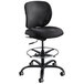 A Safco black fabric extended height office stool with a chrome base.
