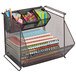 A black wire mesh Safco storage bin with sections holding stationery.