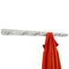 A Safco aluminum coat rack with a coat hanging on it.