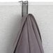 A gray coat hanging on a Safco Onyx steel mesh coat hook over a wall.