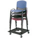 A Safco black stacking chair cart with a stack of plastic chairs.