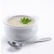 A bowl of Silver Skillet Cream of Celery soup with a silver spoon.