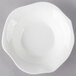 A white Villeroy & Boch bone porcelain deep plate with a wavy edge.