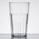 A close-up of a clear Cambro plastic tumbler with a rim.