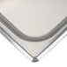 A close-up of a stainless steel solid steam table pan cover.
