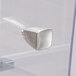 A silver metal drawer knob on a clear acrylic drawer for a bread case.