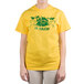 A woman wearing a yellow "We Squeeze To Please" T-shirt with a green and yellow design.