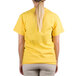 A woman wearing a "We Squeeze To Please" yellow T-shirt.