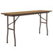 A Correll medium oak rectangular folding table with legs.