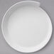 A Villeroy & Boch white porcelain plate with a curved edge on a gray background.