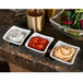 A group of Villeroy & Boch square white dip bowls filled with different dips on a counter.