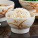 A bowl of rice with a Thunder Group Gold Orchid melamine bowl of rice on a white background.