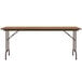 A Correll rectangular folding table with a medium oak wooden top and metal legs.
