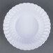 A close-up of a white Fineline Flairware plastic bowl with a wavy design.