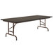 A Correll rectangular folding table with a walnut melamine top and metal frame.