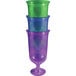 A stack of assorted jewel color hurricane cups, including blue, green, and purple.