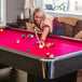 A woman playing pool on a Mizerak Donovan II pool table.