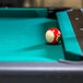 A red and white pool ball on a Triumph Phoenix pool table.