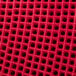 A close up of the red plastic grid on an Arachnid Cricket Pro 670 Electronic Dartboard.