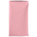A folded pink Intedge cloth napkin on a white background.