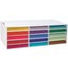 A white Pacon corrugated paper storage box with colorful paper in it.