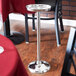 An American Metalcraft wine bucket stand on a metal table.