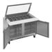 A Beverage-Air stainless steel refrigerated sandwich prep table with two glass lids open.