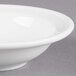 A Libbey alpine white porcelain fruit bowl with a rim.