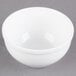 A white Libbey Alpine porcelain bowl on a gray surface.