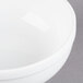 A close-up of a Libbey Alpine White Porcelain Nappie Bowl with a white rim.