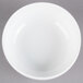 A Libbey Alpine White Porcelain Nappie bowl on a gray surface.