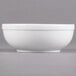 A white Libbey Alpine nappie bowl on a gray surface.
