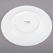 A white Libbey porcelain plate with black text that reads "Empire" and a welle design.