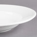 A close up of a white Libbey Alpine porcelain pasta bowl with a rim.