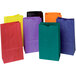 A group of Pacon rainbow colored uncoated kraft paper bags in blue, green, orange, purple, and white with green stripes.