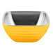 A yellow Vollrath beehive bowl with a stainless steel rim.