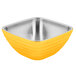 A Vollrath square stainless steel serving bowl with a yellow rim.