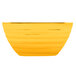 A yellow Vollrath square serving bowl.