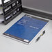 A TOPS Docket Diamond planner pad with a pen on a table.
