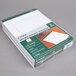 A white box with a stack of white and green TOPS writing pads.
