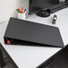 A black Cardinal Premier Easy Open binder on a desk.