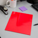 A red Oxford high gloss laminated paper pocket folder on a desk.