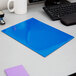 A blue Oxford 2-pocket folder on a table next to a keyboard.