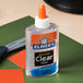 A bottle of Elmer's clear glue on a table.
