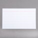 A white Oxford index card with red lines.