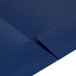 An Oxford navy blue paper pocket folder with a linen finish and white strip on the edge.