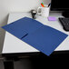 A navy blue Oxford linen paper pocket folder on a table.