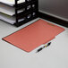 A stack of Pendaflex legal size moisture-resistant classification folders on a desk.
