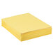 A stack of yellow Oxford letter size paper folders.