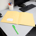 A yellow Oxford 2-pocket folder on a white desk.